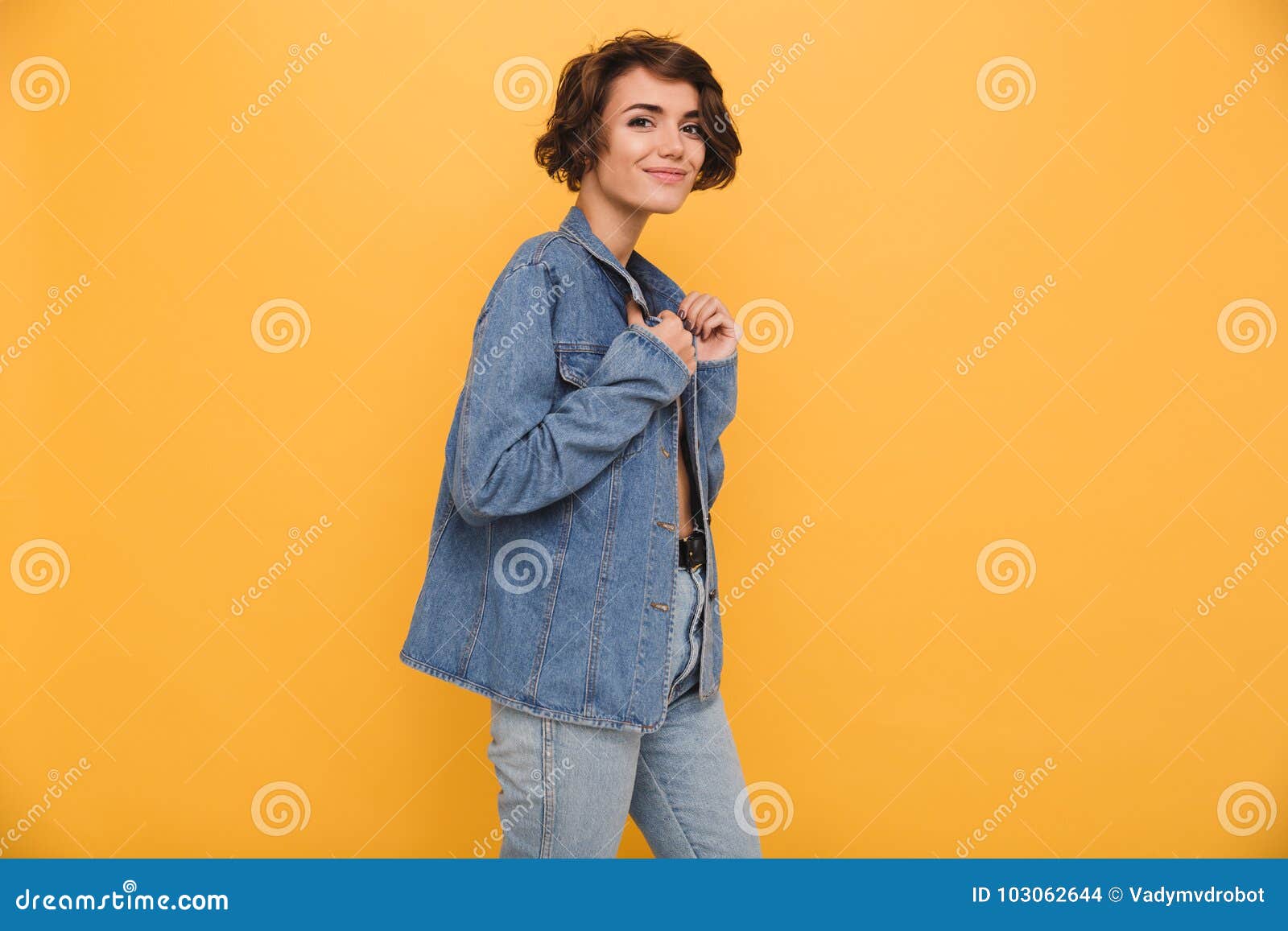 Portrait Of A Young Smiling Woman Dressed In Denim Jacket Stock Photo ...