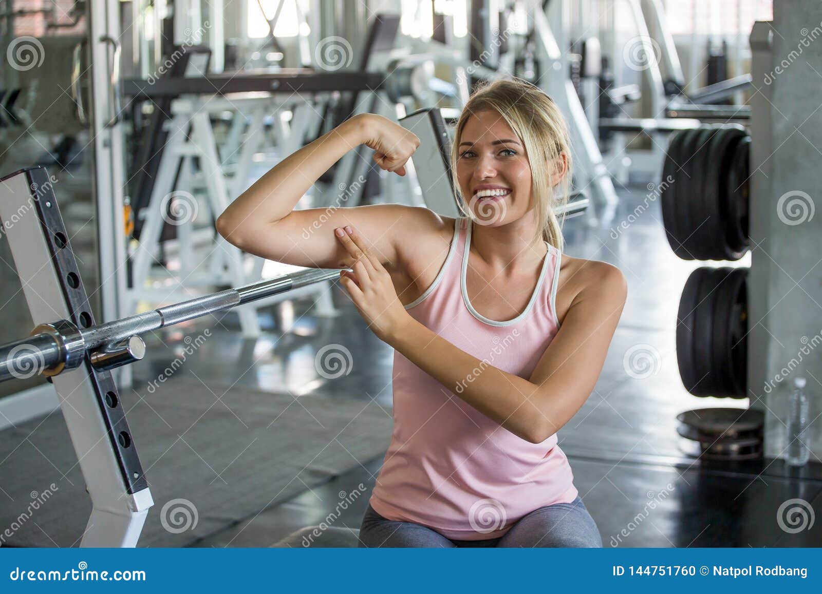 Portrait Of Young Sport Woman In Sportswear Posing Strong Showing Her Biceps Muscular Arms In