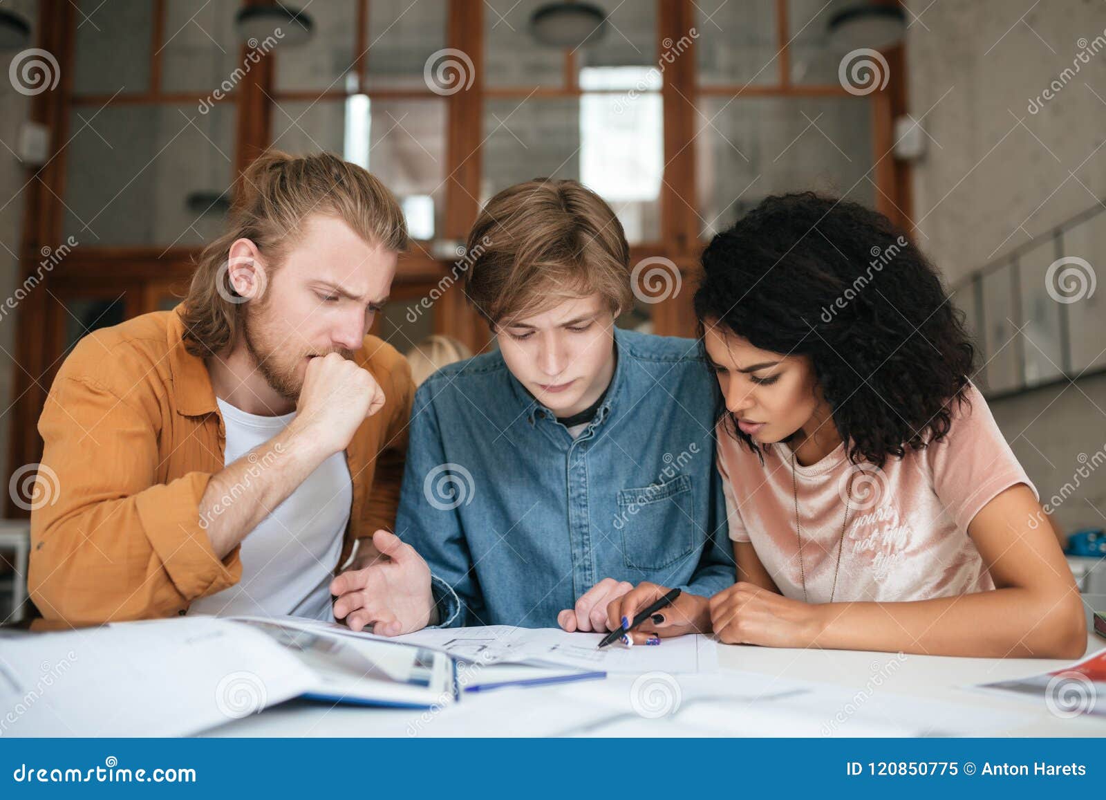 Young Thoughtful People Working In Office Two Boys With