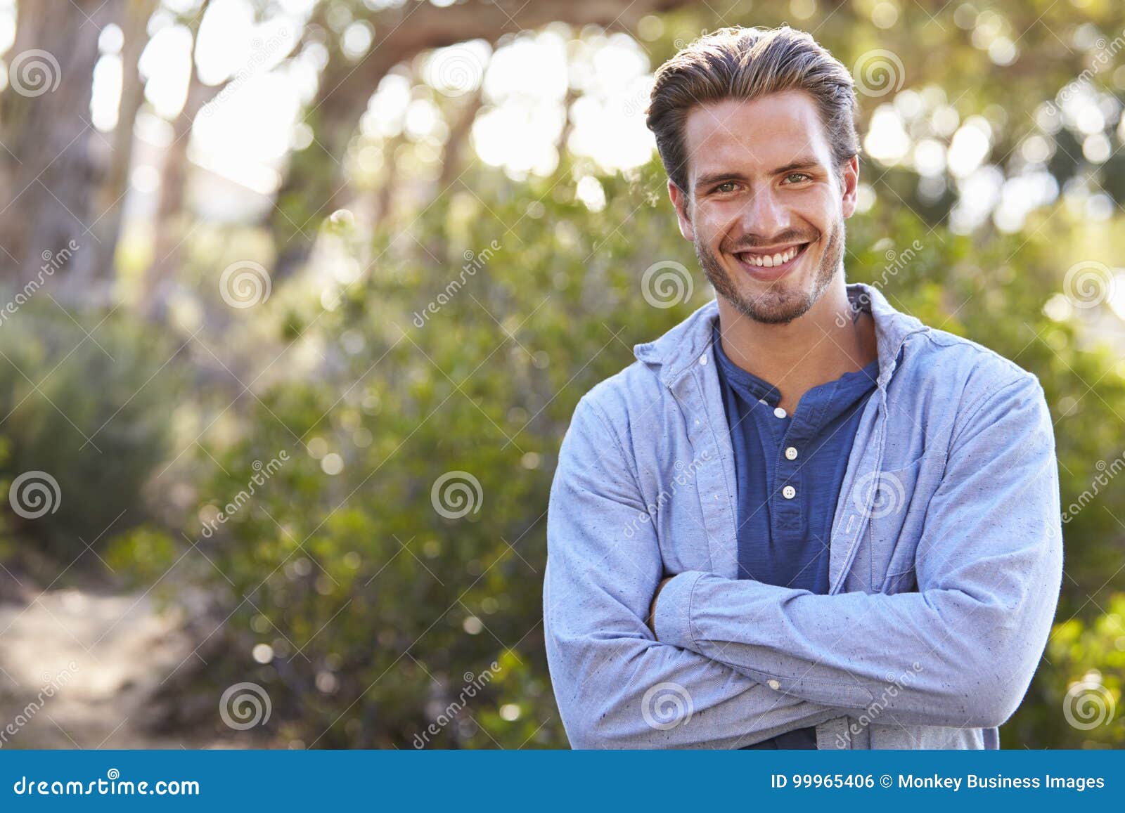 Portrait of Young White Man Smiling Arms Crossed Outdoors Stock Photo ...