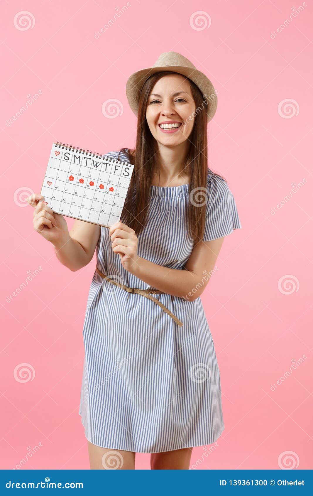 Portrait Of Happy Woman In Blue Dress Hat Holding Periods Calendar For