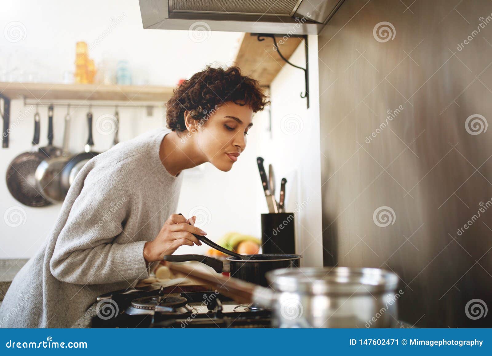 Woman stirring giant cooking pot hi-res stock photography and images - Alamy