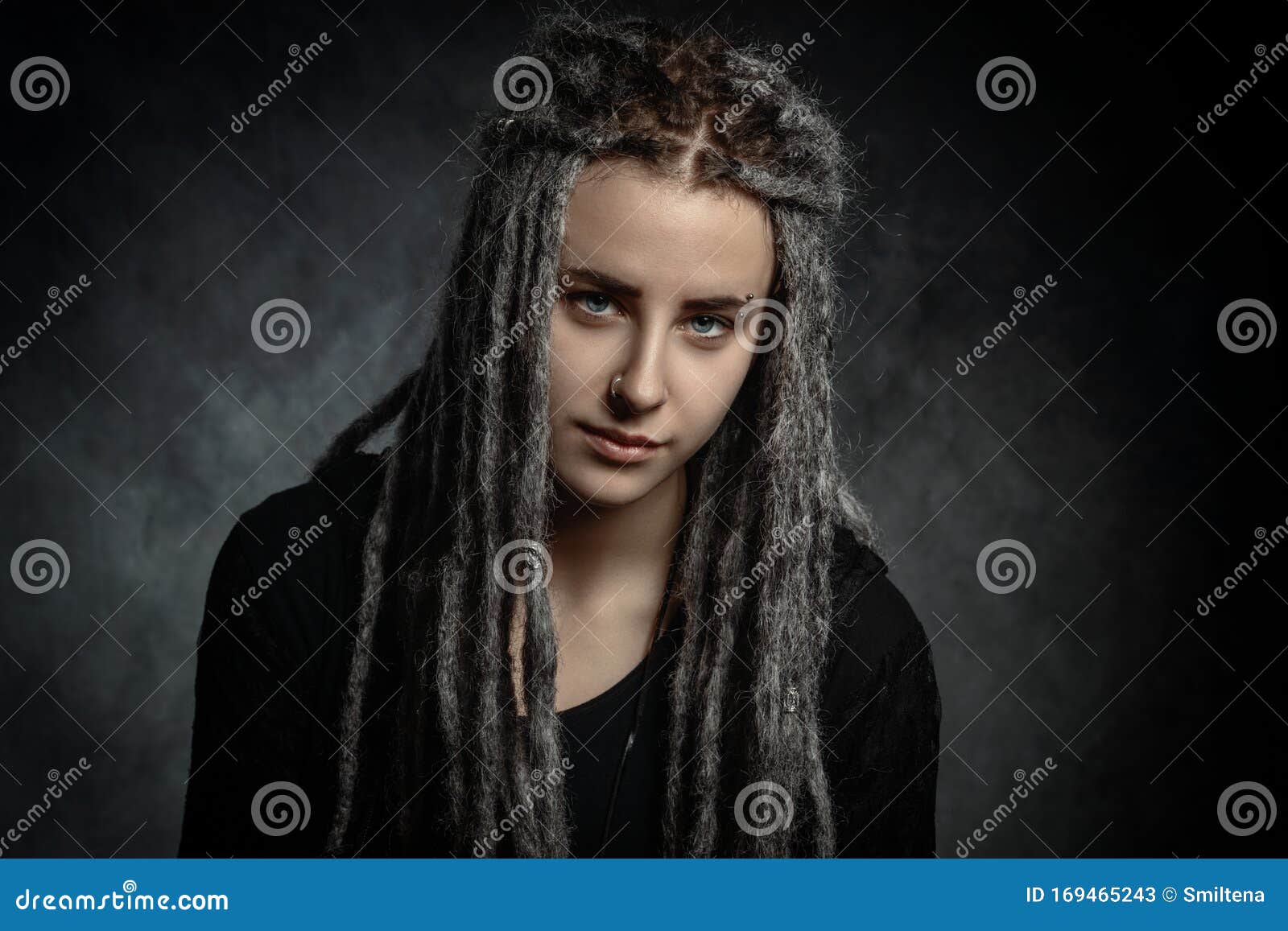 Portrait of a Young Woman with Dreadlocks Against Dark Background Stock ...