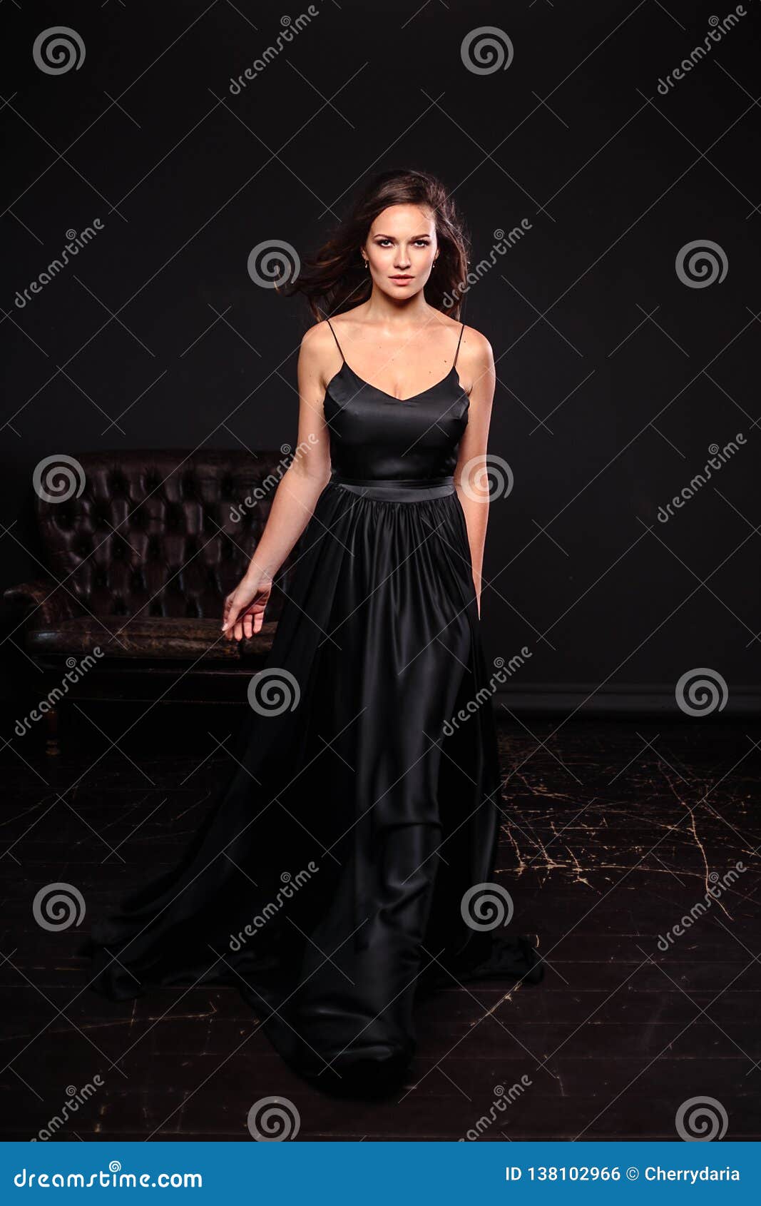 Portrait of Young Woman in Elegant Silk Black Dress Posing in a Dark ...
