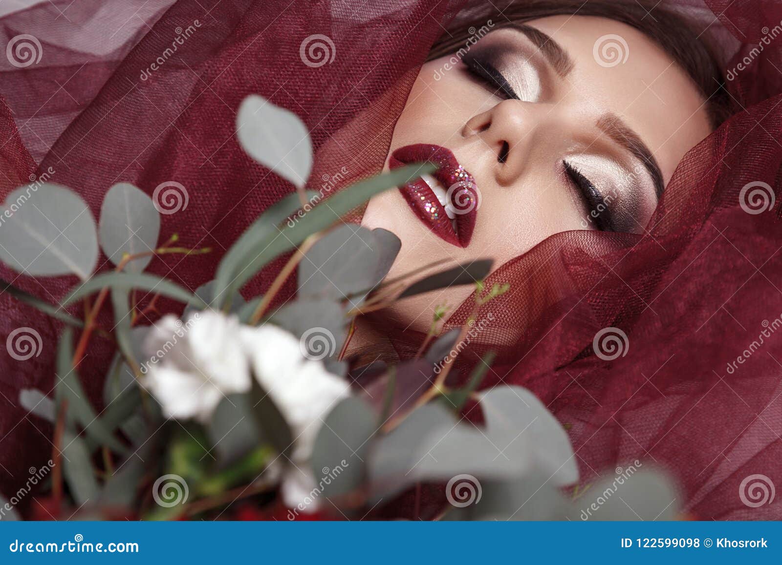 portrait of young woman with fashionable makeup and eucalyptus b