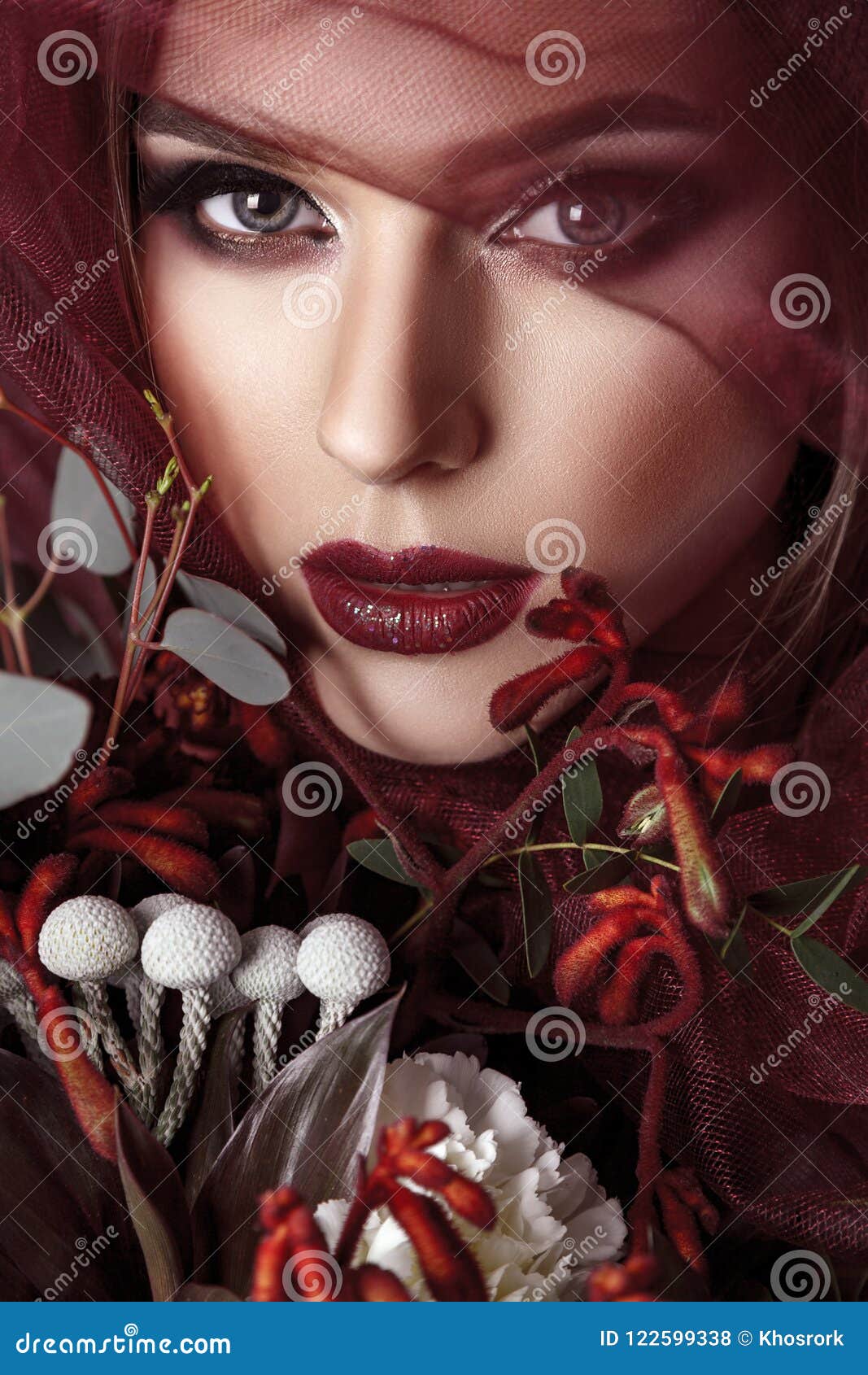 portrait of young woman with fashionable makeup and eucalyptus b