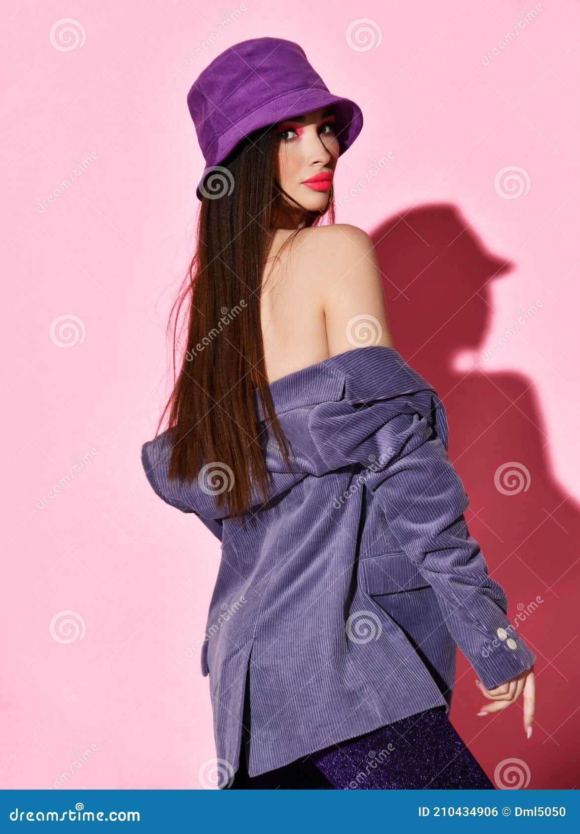 https://thumbs.dreamstime.com/z/portrait-young-woman-purple-hat-shimmering-pants-slipping-down-shirt-exposing-her-shoulders-standing-back-portrait-210434906.jpg