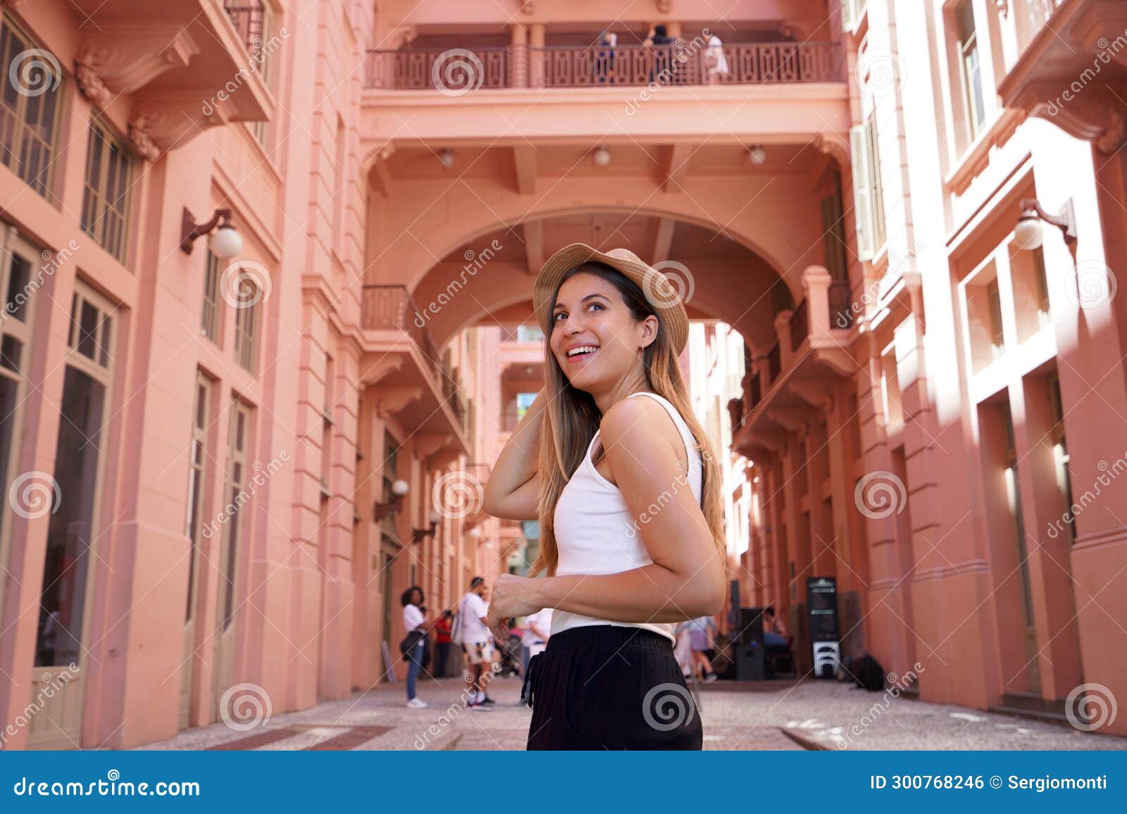 portrait of young woman visiting the historic palace casa de cultura mario quintana in porto alegre, brazil