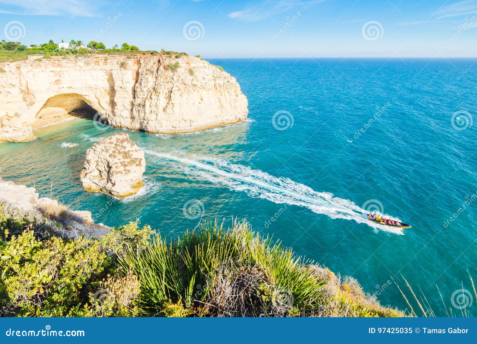 portugal algarve beach cave visited by experience boat.