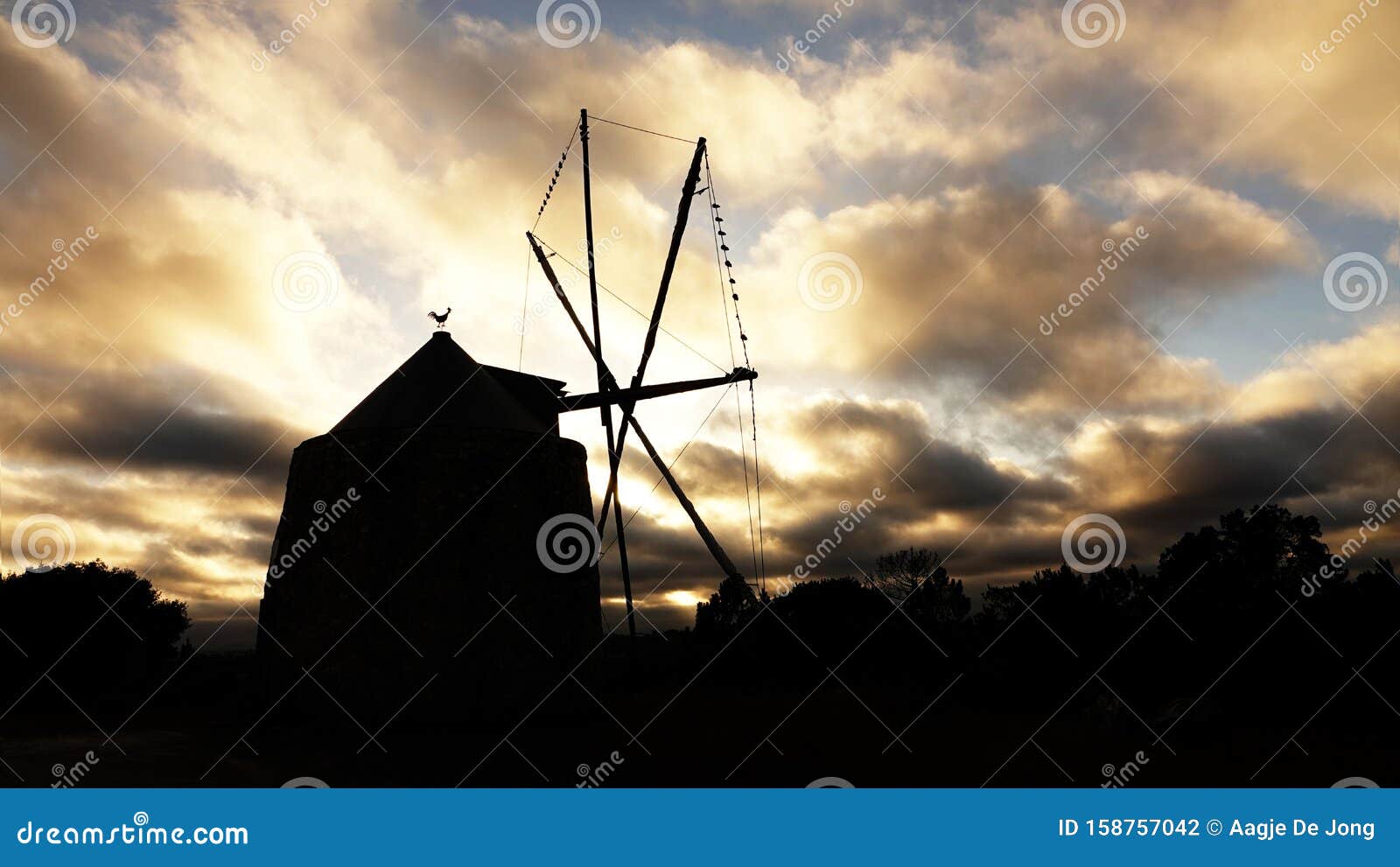 portugese windmill in pedreias in portugal at sunset