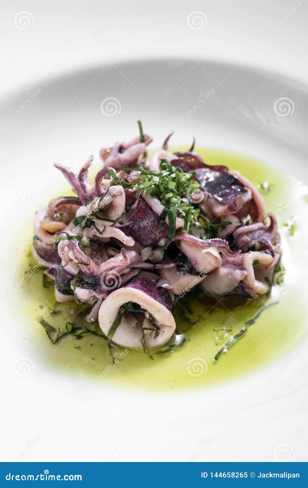 portuguese traditional fresh seafood marinated squid salad in coriander oil