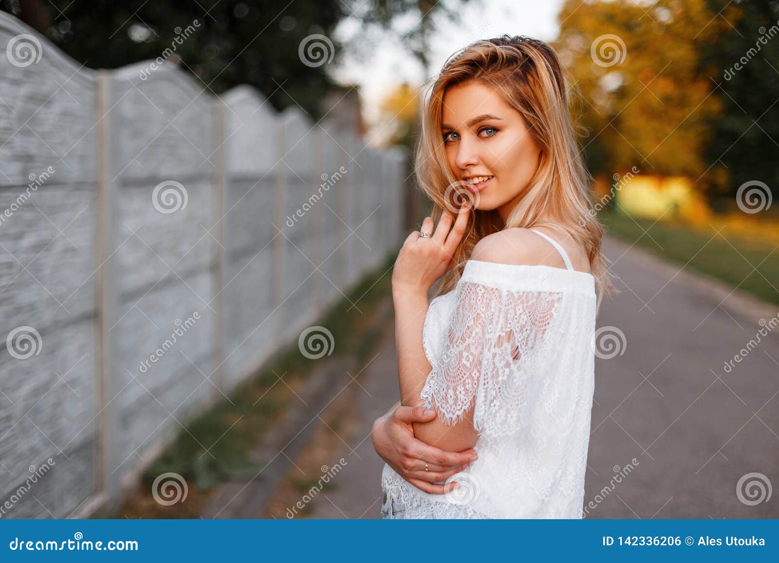 Positive Attractive Young Woman In An Elegant Lace Blouse Posing