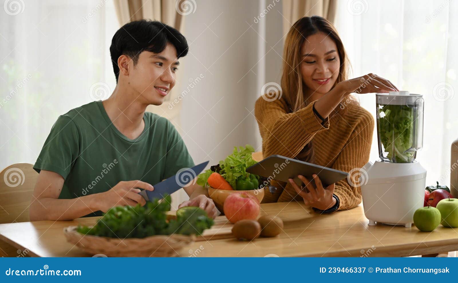 Couple Cooking Healthy Green Smoothie Together in Kitchen at Home