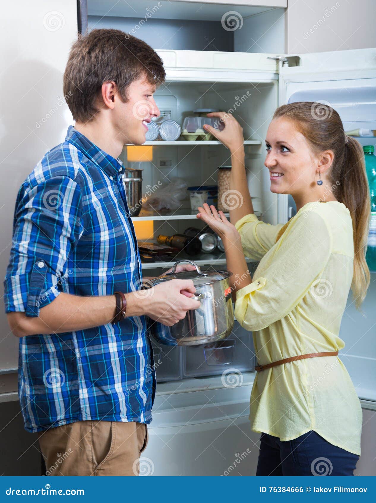 positive family searching food on fridge