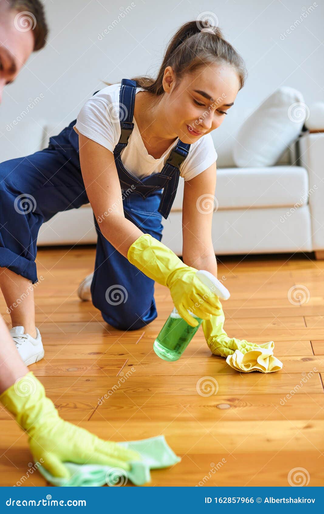 Positive Female Cleaner Polishing Floor With Rag And Spray Stock