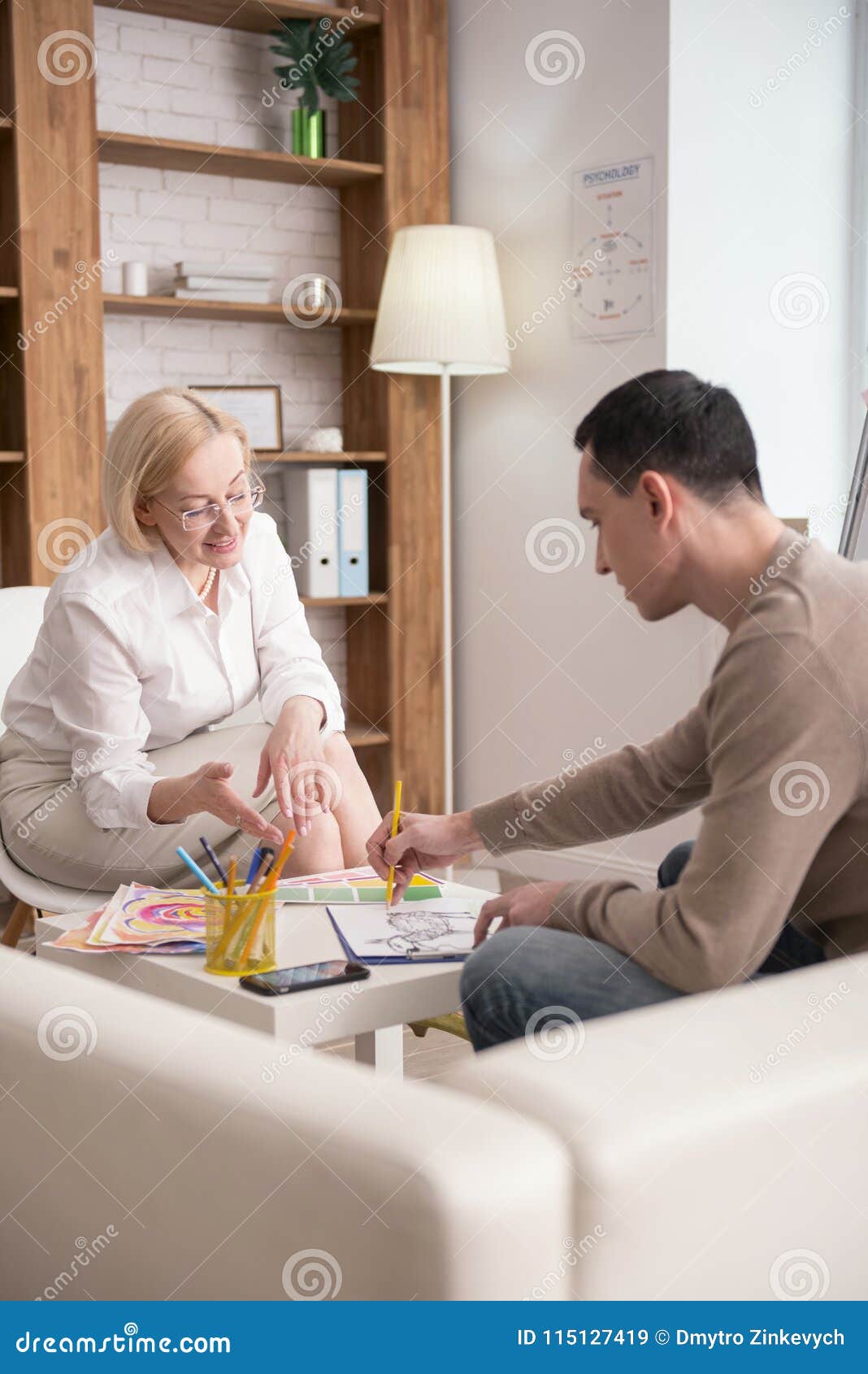 Positive Mature Psychologist Pointing at Elements Stock Image Image