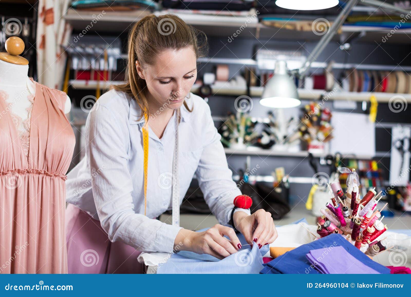 Woman Worker Sew Up Textile Material at Sewing Stock Photo