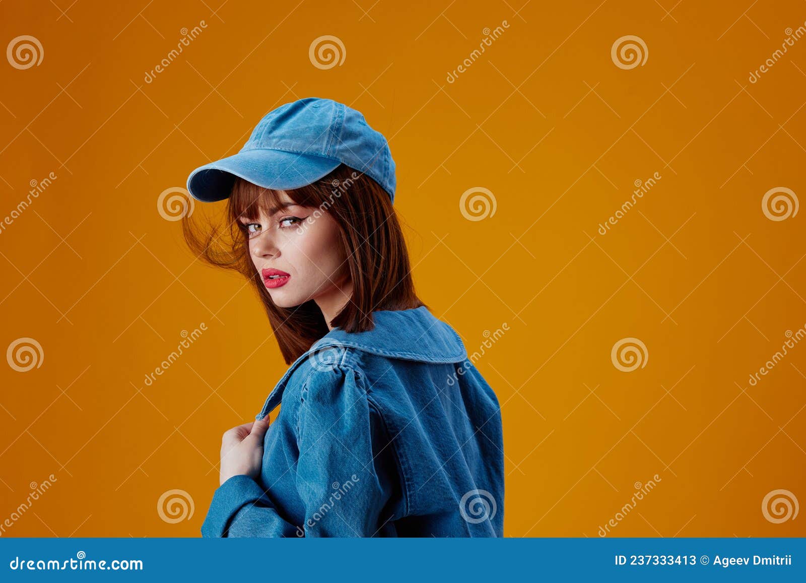 Positive young woman denim clothing fashion posing cap color