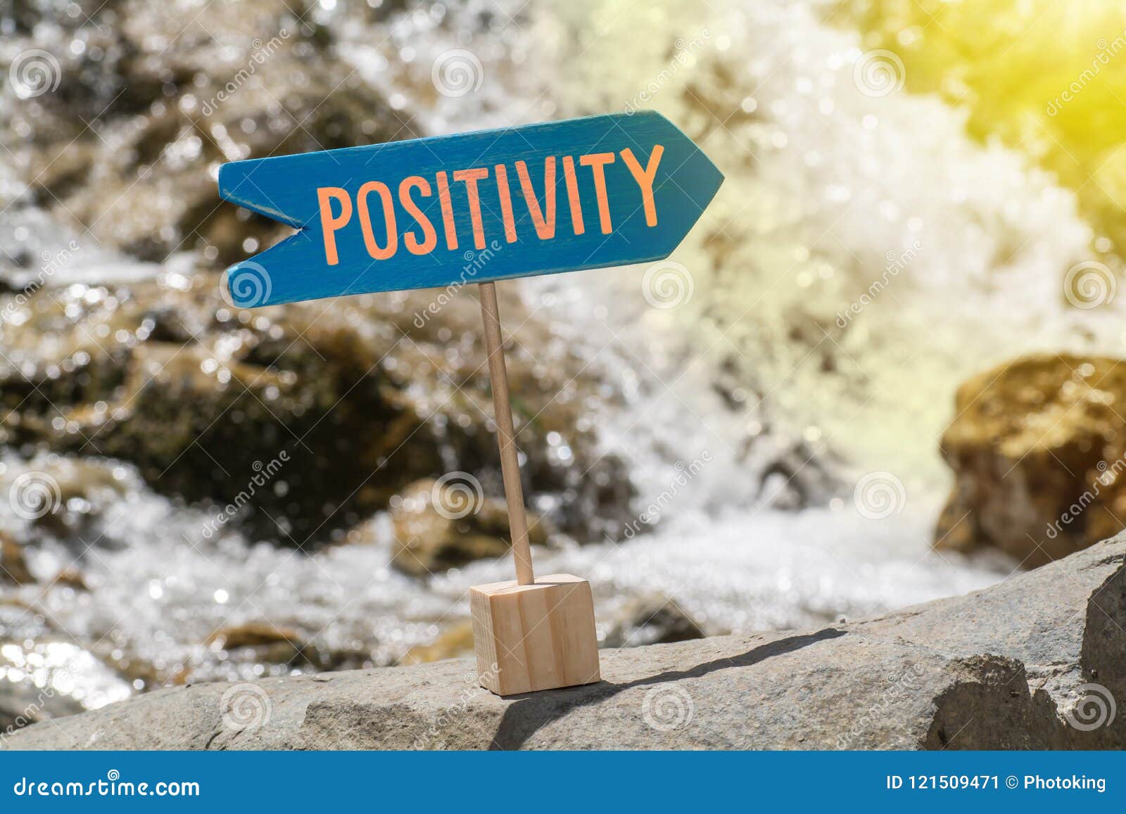 positivity sign board on rock