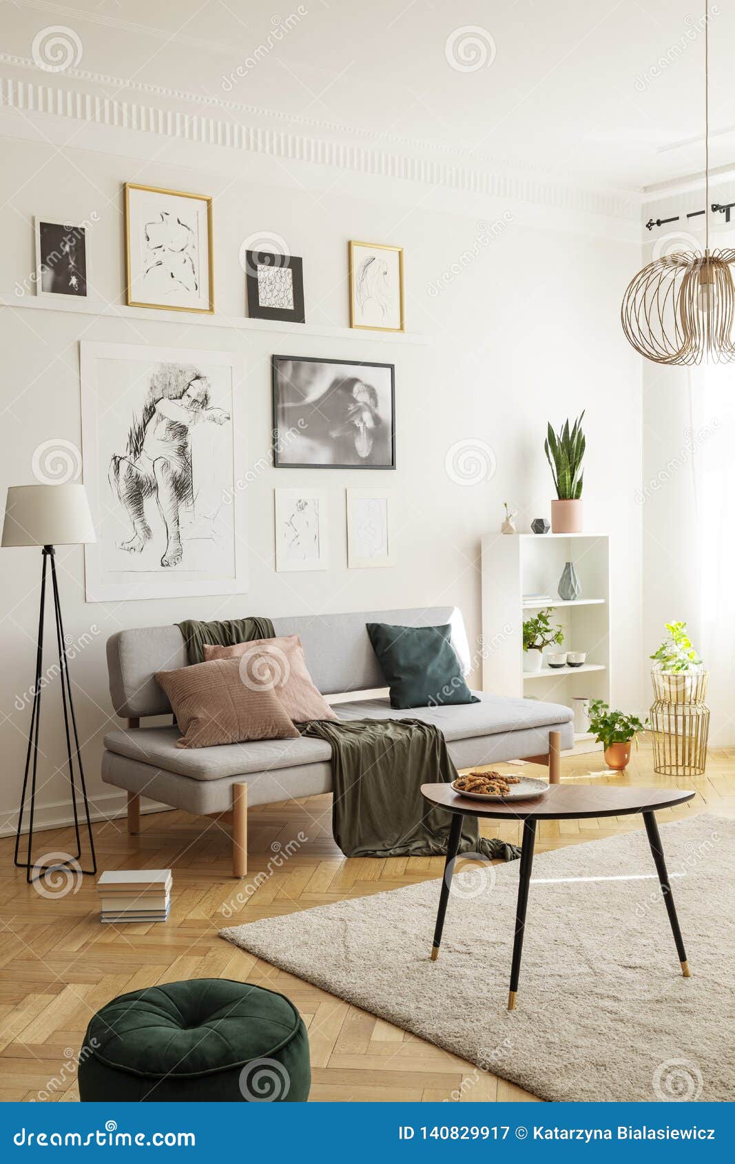Posters Above Settee With Pillows In Bright Living Room 