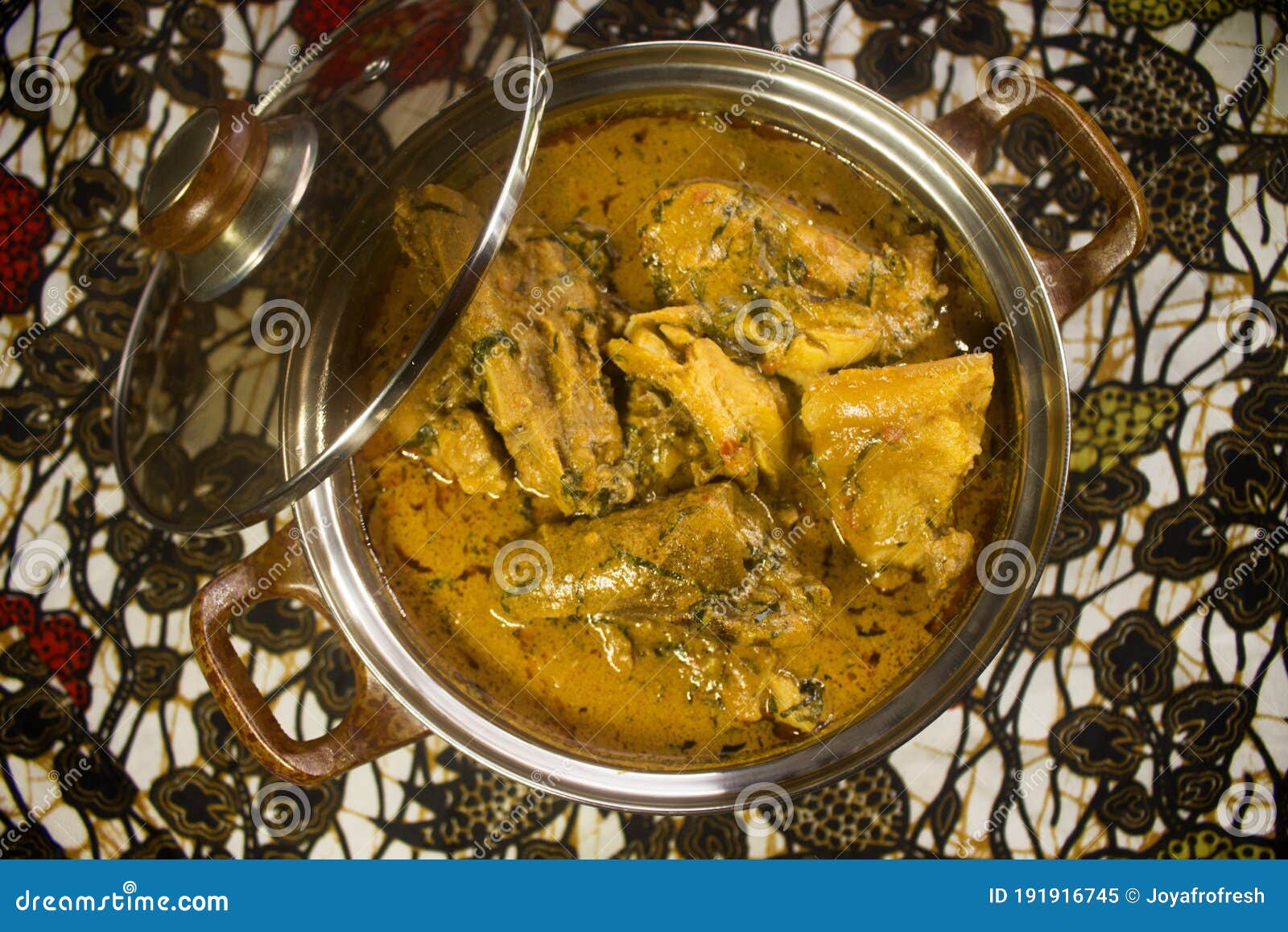 a pot of delicious groundnut soup looking like nigerian banga soup