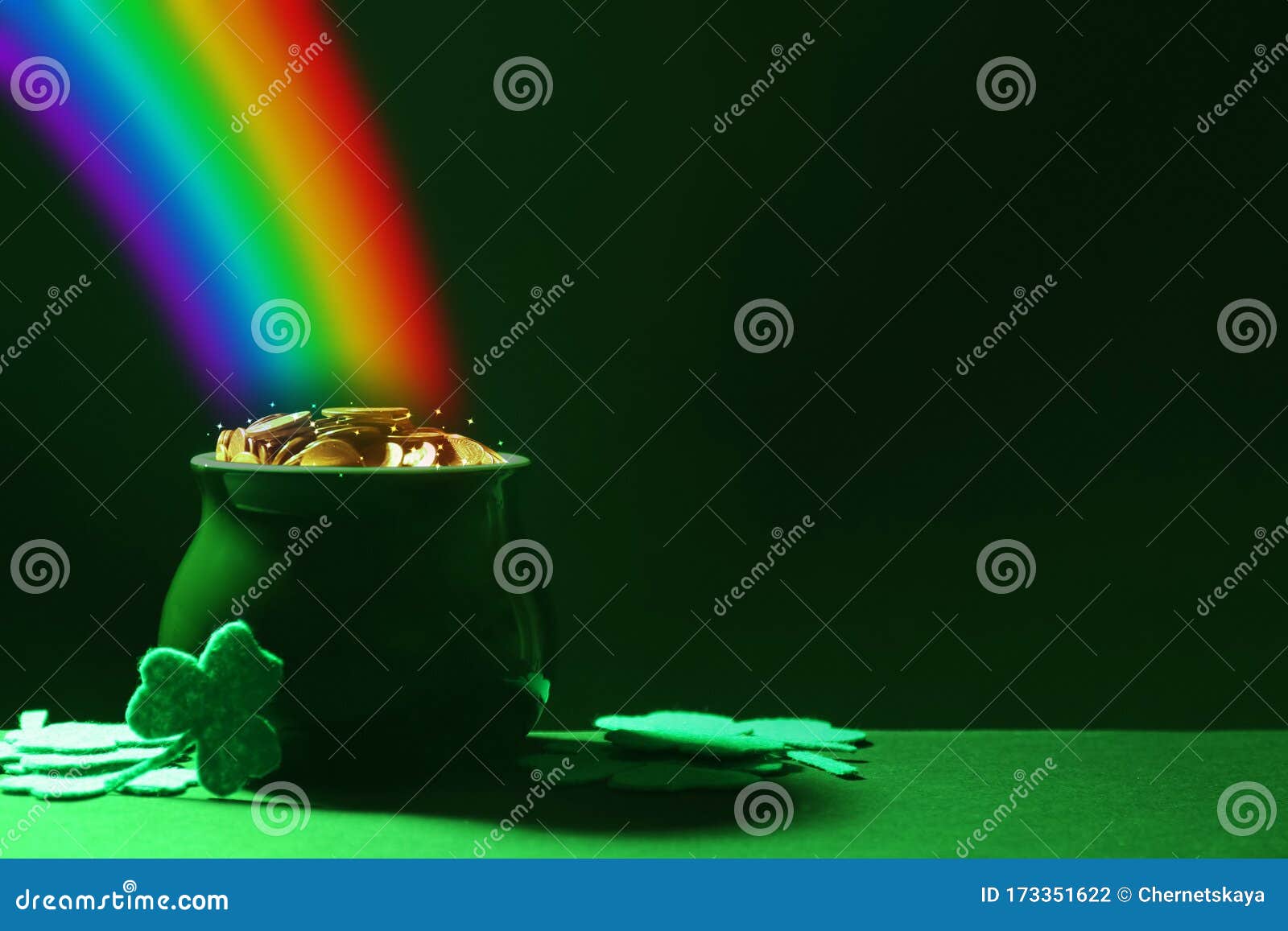 pot with gold coins and clover leaves on table, space for text. st. patrick`s day celebration