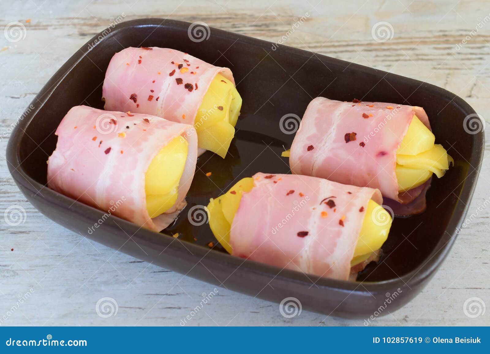 potato with cheese wrapped in bacon in a ceramic form
