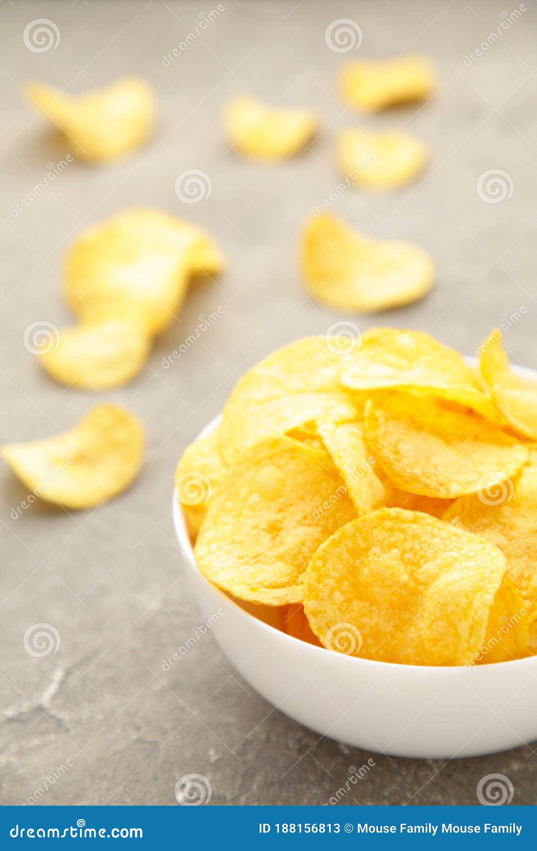 Potato Chips on Bowl on Grey Concrete Background. Top View Stock Image
