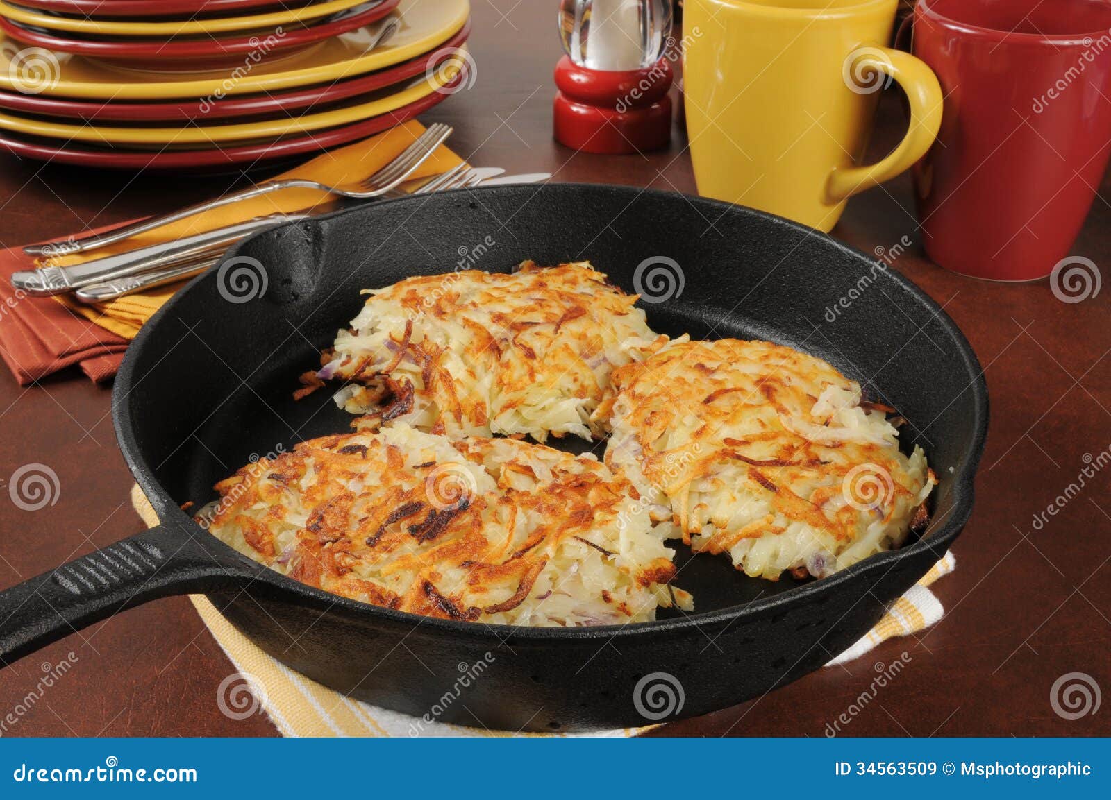 Golden fried potato latkes in a cast iron skillet