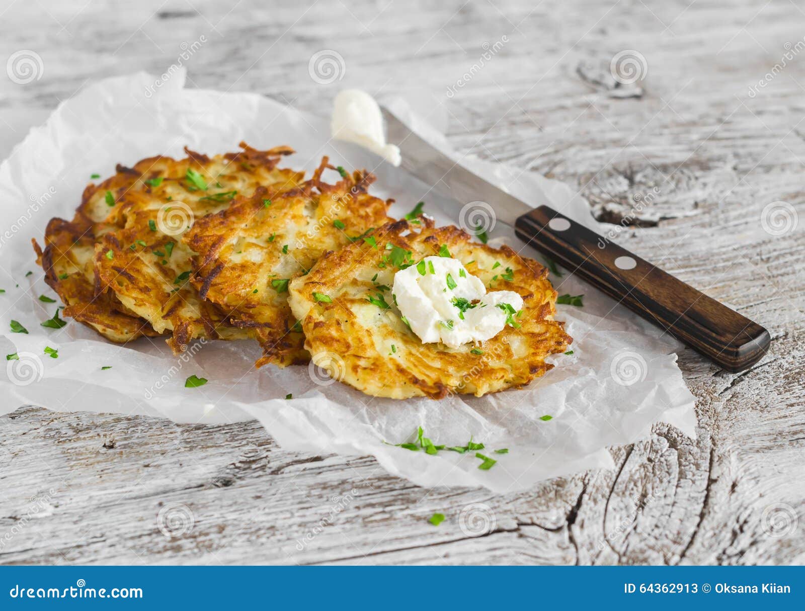 potato pancakes or latkes on a light rustic wood surface