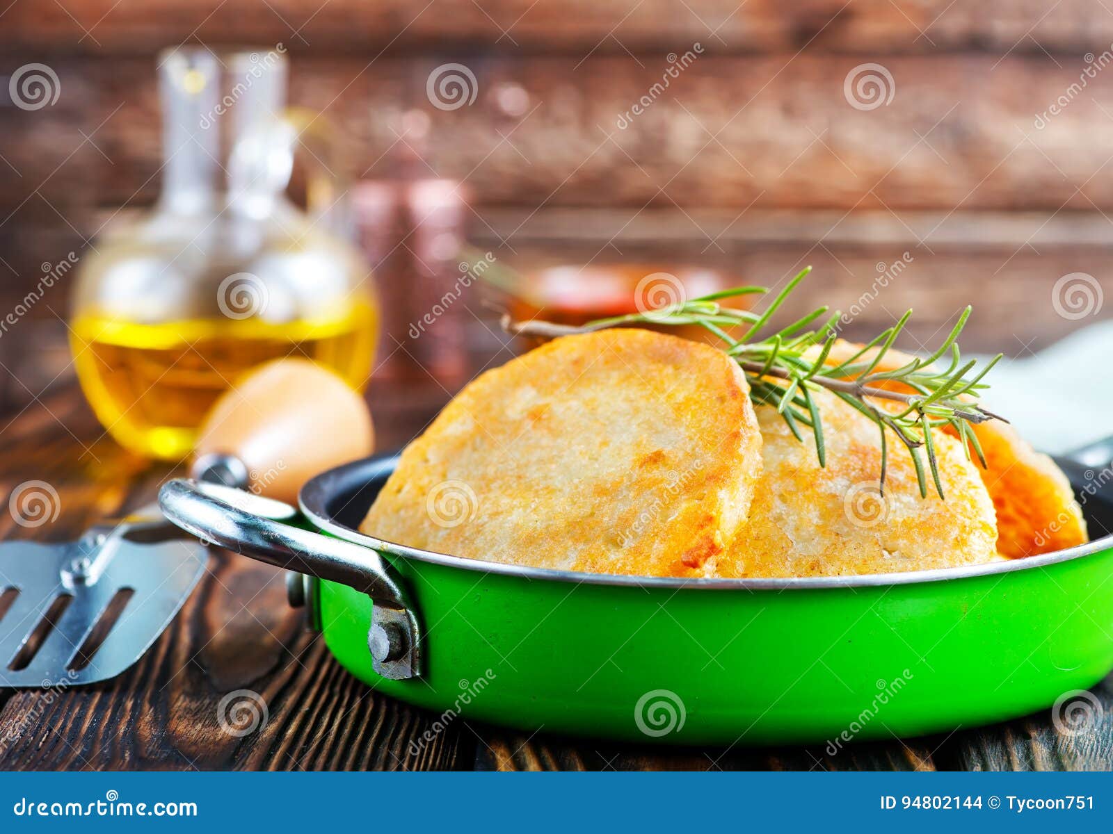 Potato pancakes in pan and on a table