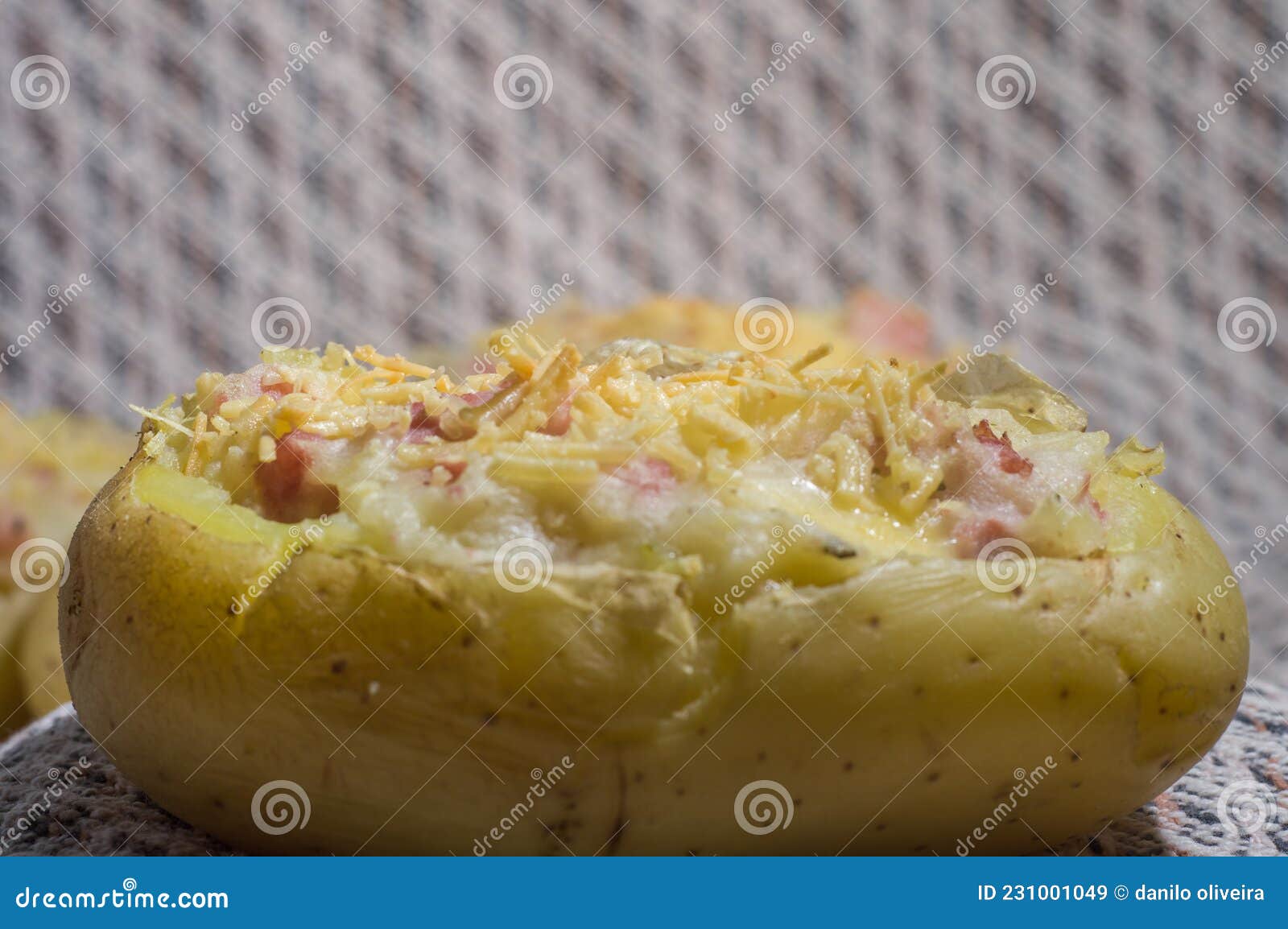 Potato Stuffed with Cheese, Sausage and Ham and a Table Cloth in the
