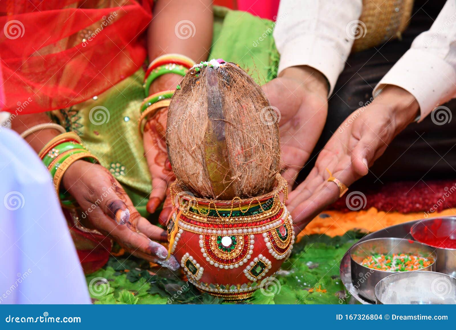 pote and coconut with man and woman hand