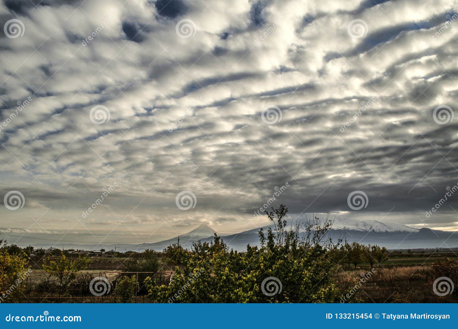 sky late autumn above the valley of mount ararat darkened from the accumulated layered-cumulus clouds