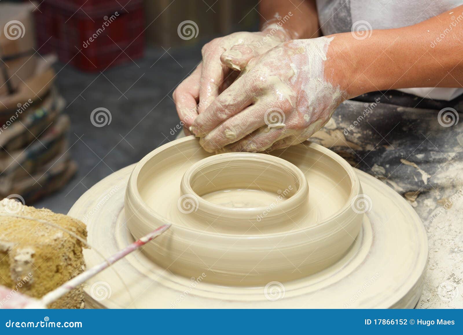 potter shaping clay in pottery