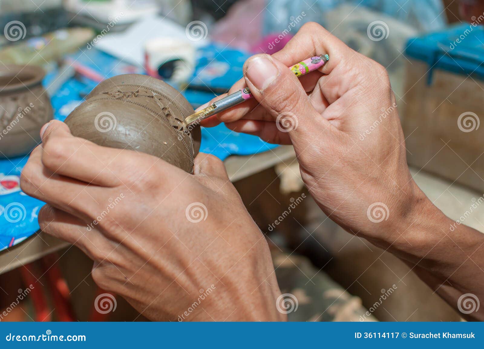 Pottery carving in hand stock image. Image of molding 36114117