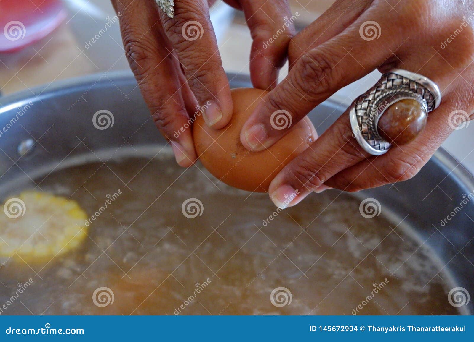 Pounding Eggs in Boiling Water. Stock Photo Image of water, eggs 145672904