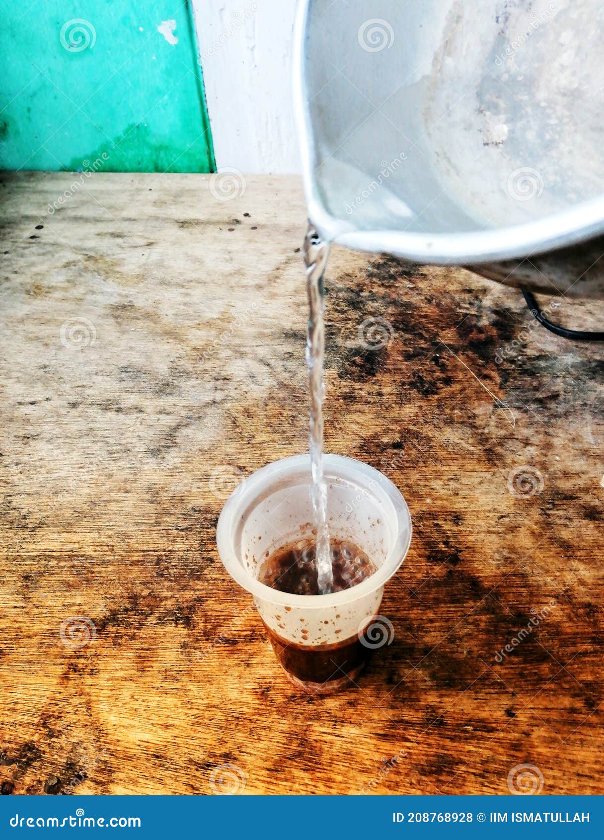 Pour Hot Water into a Glass Filled with Coffee Grounds Stock Photo