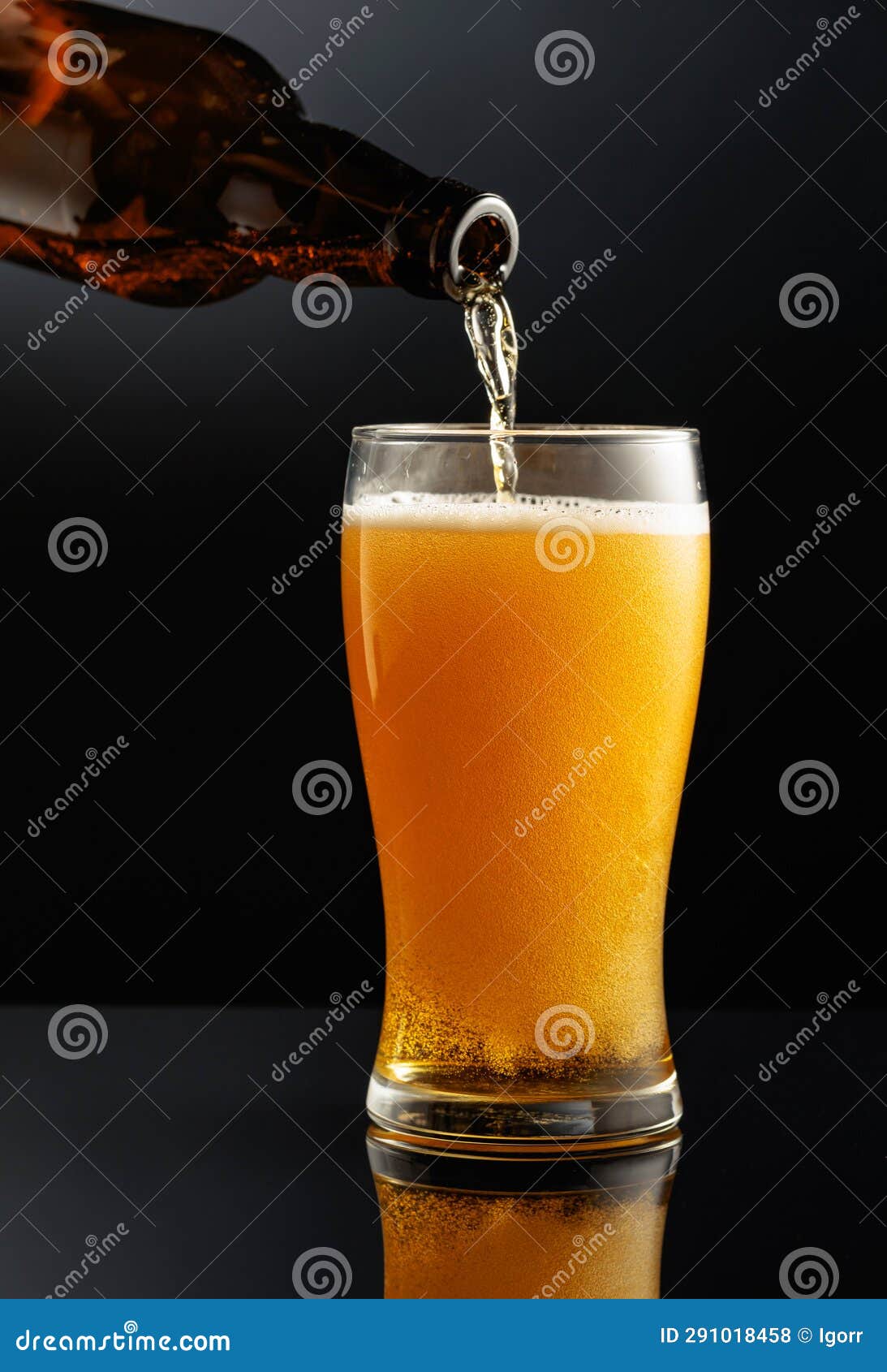 Pouring Beer from a Bottle into a Glass Stock Photo Image of brew