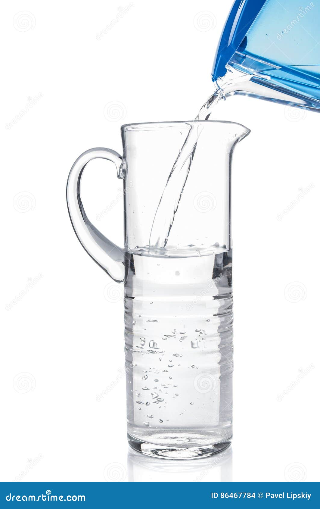 Pouring Clear Water from Filter Pitcher in Glass Jug Stock Photo
