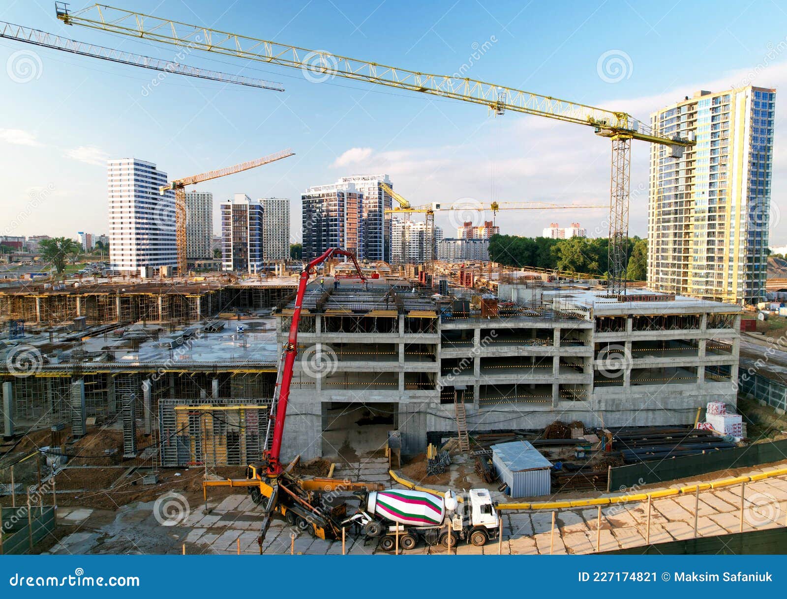 pouring concrete from cement mixer. tower crane on formwork at construction site. reinforced concreting. falsework, Ã¢â¬â¹frames and