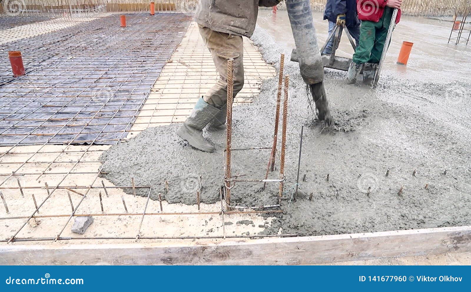 Pouring Concrete Mix from Cement Mixer on Concreting Formwork. a Group