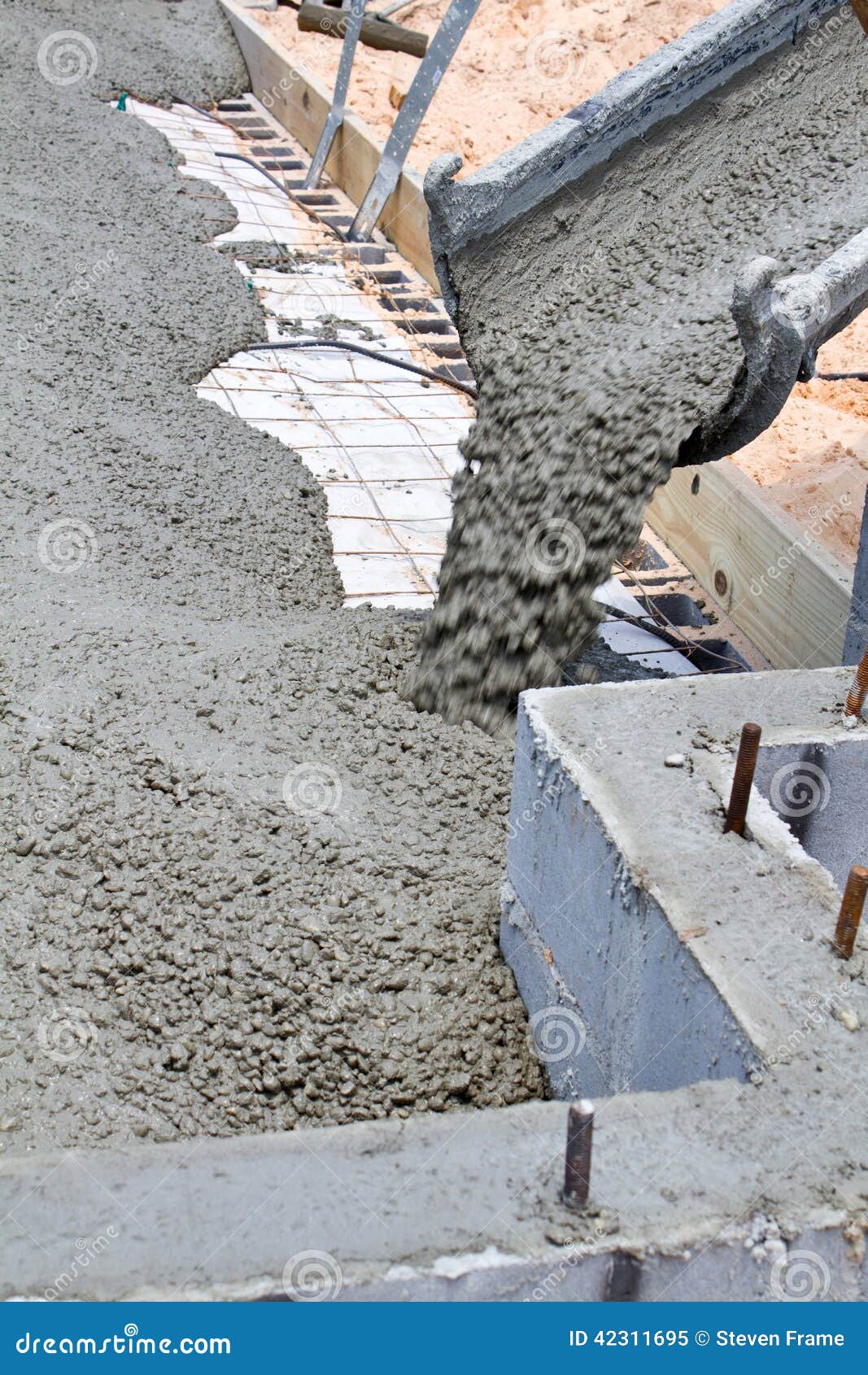 pouring concrete slab wet cement pours down truck chute to fill home building construction site 42311695