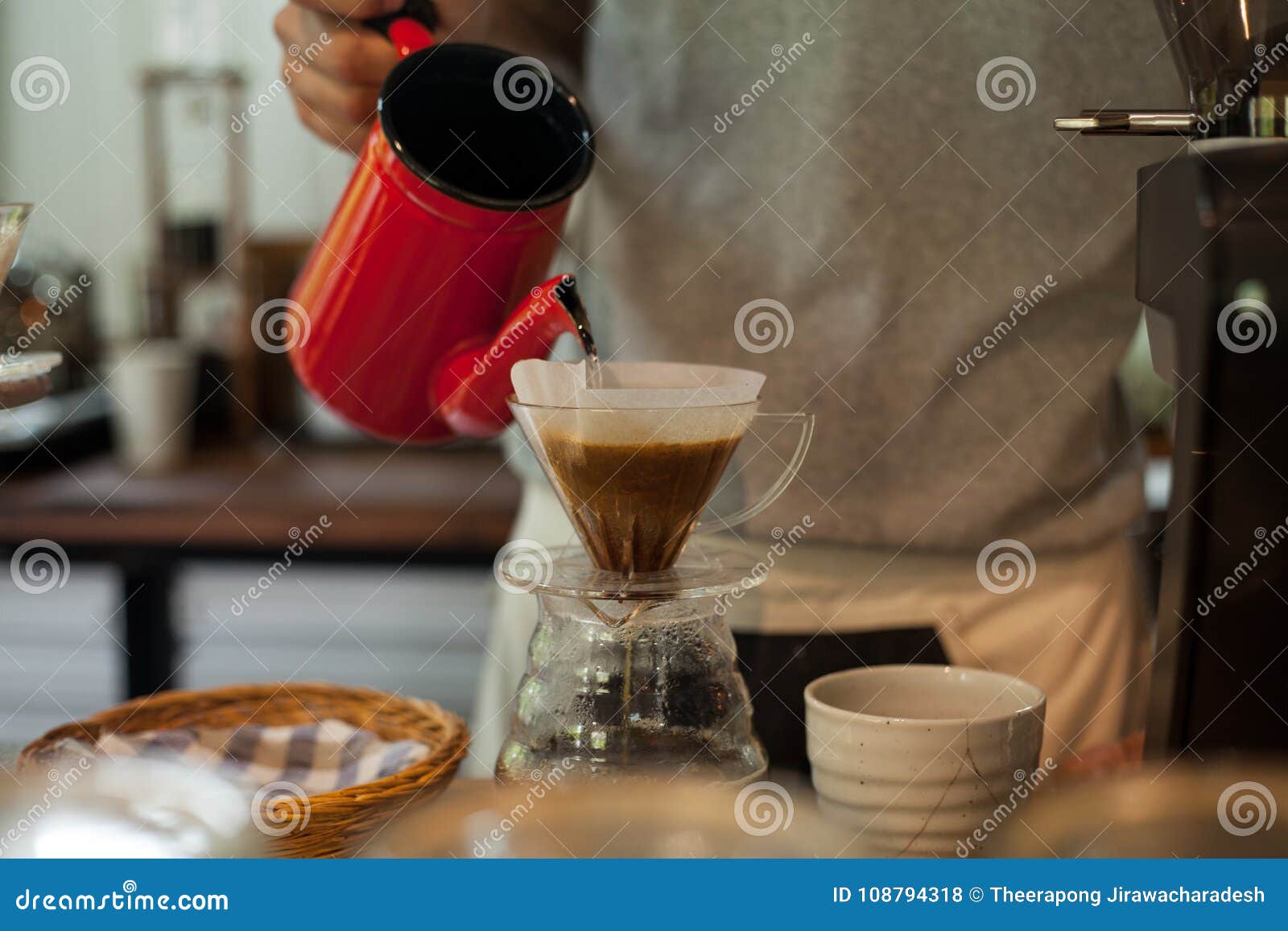 Man Pouring Hot Drip Coffee In Temperature Bottle For The Other In The