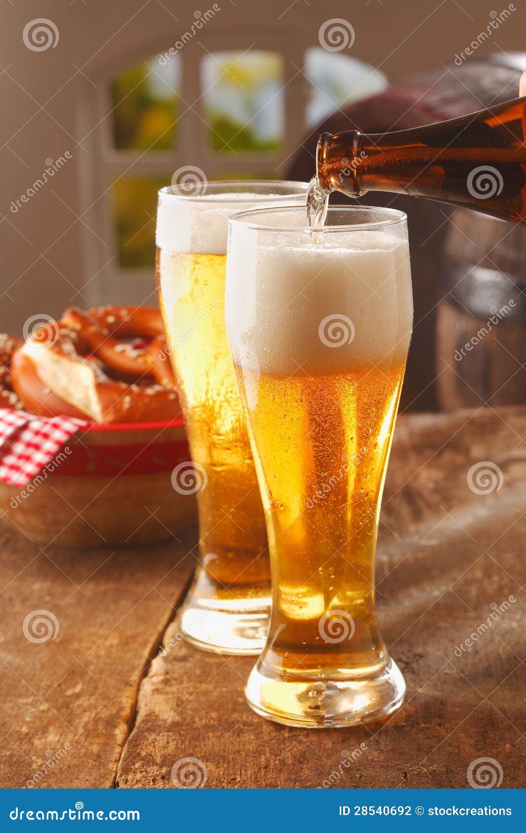 pouring glasses of frothy beer