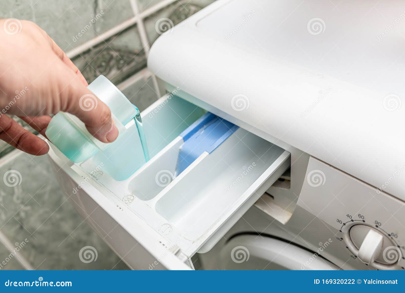 Pouring laundry detergent stock photo. Image of laundromat 169320222