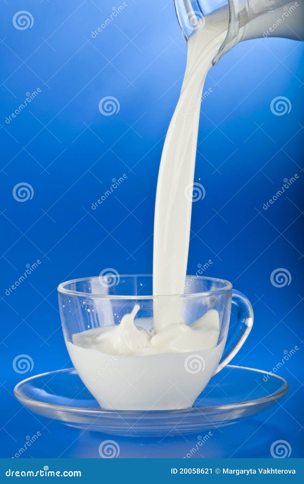 Pouring milk into a cup stock image. Image of action 20058621