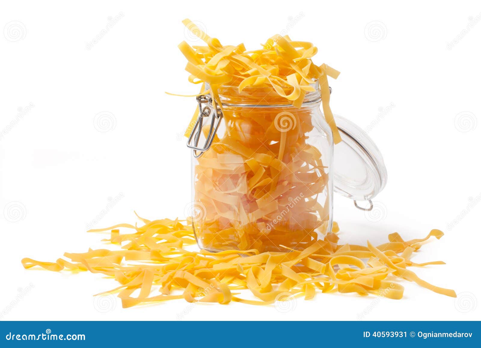 Pouring Pasta In A Jar. Typical italian food pasta in a jar isolated on white.