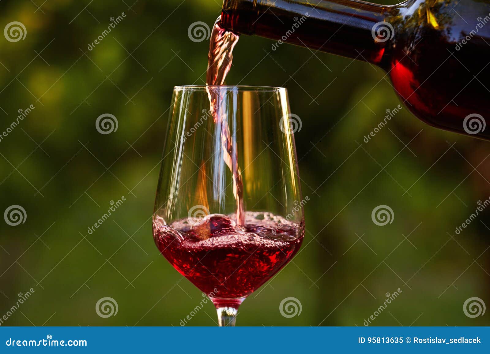 pouring red wine into glass