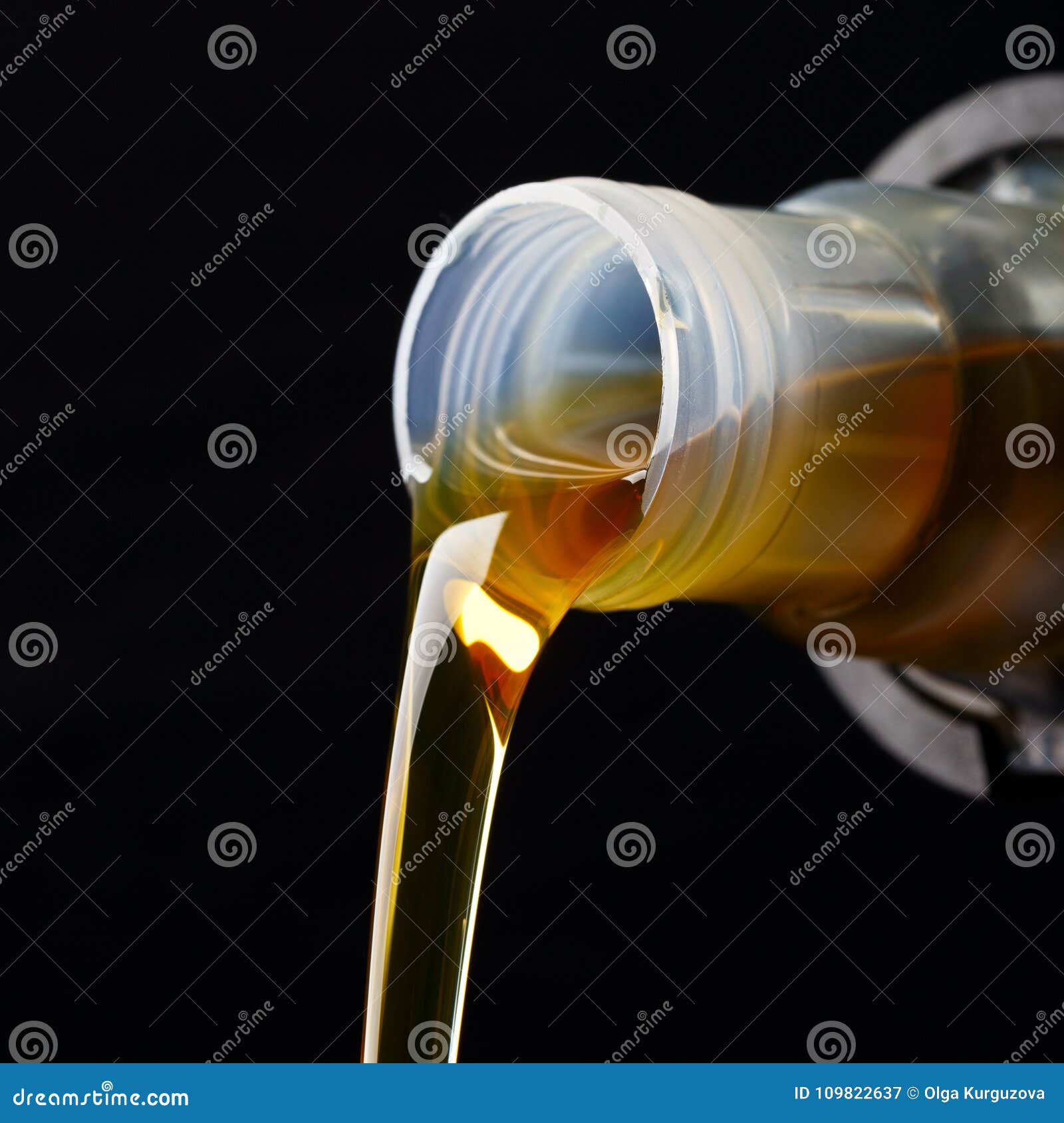 Pouring Synthetic Oils For Car Engine On Dark Background. RoyaltyFree